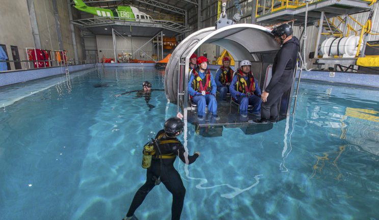Trainees learning safety procedures during in emergencies in the Helicopter Underwater Escape Training course